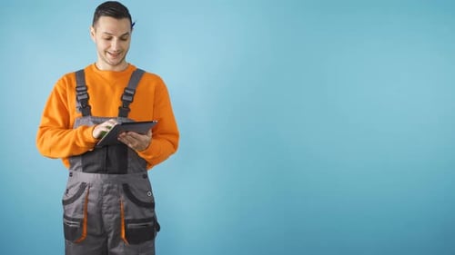 Confident Construction Worker or Architect Working on Tablet