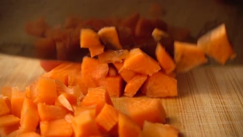 Fresh Carrot Diced into Cubes on Wooden Board
