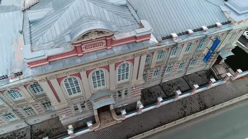 Gorgeous Building on City Street and Cars Drive Along Road