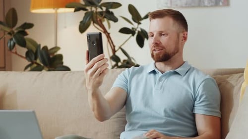 Man Video Chatting at Home on Phone