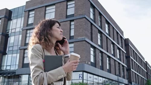 Woman Walking and Talking on Phone in City