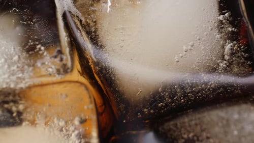 Close Up of Ice Cubes in Dark Liquid