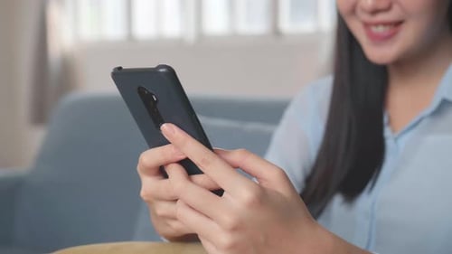 Woman Using Smartphone at Home Indoors
