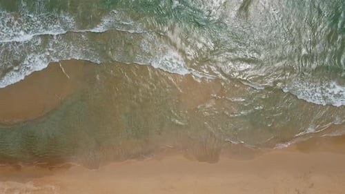 Aerial view of white sand beach and ocean wave
