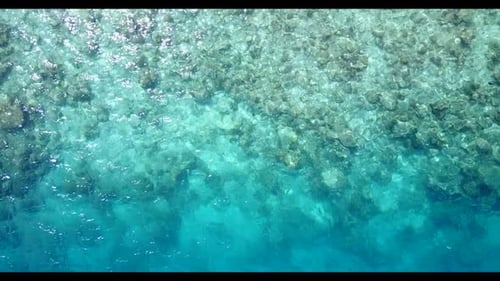 Aerial above seascape of exotic island beach holiday by clear lagoon with clean sandy background of