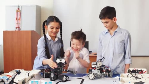 Group of Kids Choose Parts of Robotic Toys for Building Robots at School Lesson