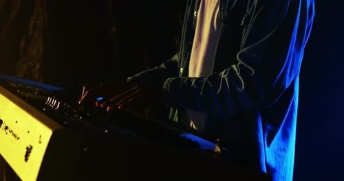 Musician Plays Electronic Keyboard in Concert