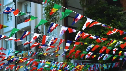 Colorful Flags of the World Hang Over Street
