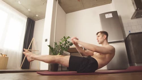 Shirtless Man Doing Torso Twists on Exercise Mat