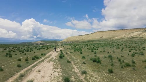 People Rides Bicycle on the Mountain Road Top View