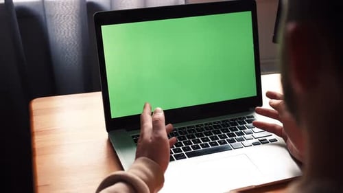 Young Caucasian Man at Home Office Sits Table Communicates Talk Speak with Green Screen Laptop
