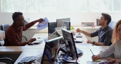 Side view of young cool mixed-race business team working at desk in a modern office 4k