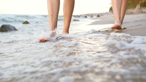 Barefoot Couple Walking on Sandy Ocean Beach