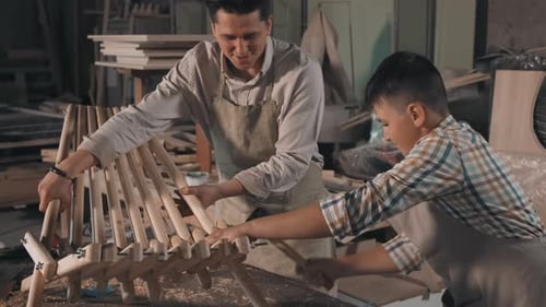 Boy Hammering In Carpentry Workshop