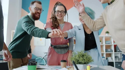 Portrait of Business Team Girls and Guys Joining Hands Expressing Unity in Office