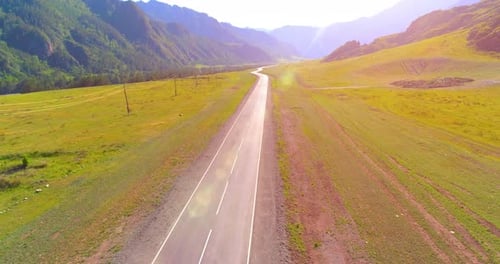 Flight Over Mountain Asphalt Highway Road and Meadow