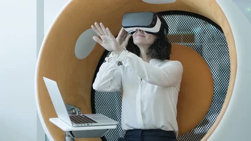 Woman Using Virtual Reality Headset in Futuristic Pod