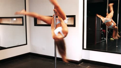 Woman Dancing on a Pole in Studio