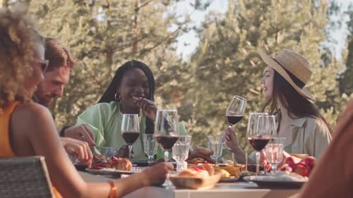 Friends Enjoying Brunch and Wine at Outdoor Table