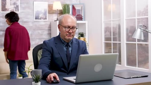 Mature Man Working at Desk at Home