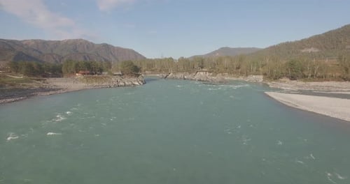 Low Altitude Flight Over Fresh Fast Mountain River with Rocks at Sunny Summer Morning.