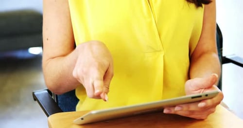 Woman Uses Tablet in Bright Office Setting