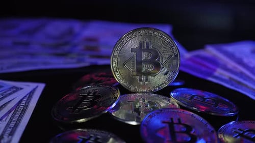 Close Up of Bitcoins with Dollar Bills