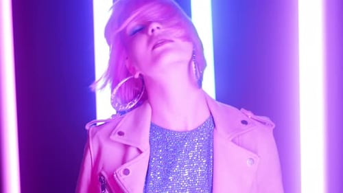 Stylish Woman with Pink Hair Posing in Neon Lights