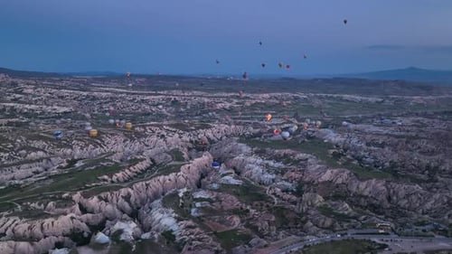 4K Aerial view of Goreme. Colorful hot air balloons fly over the valleys.