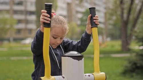 Slow Motion Mother and Daughter Doing Exercises on Open Air Sport Playground. Sportive Family