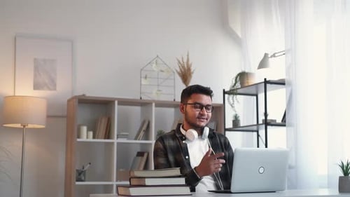 Young Adult Attending a Video Call at Home