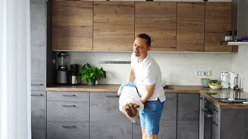 Dad and Daughter Playing Happily in Kitchen