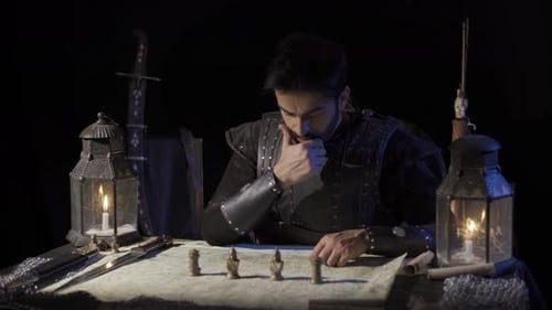 Military Leader Planning Strategy by Candlelight