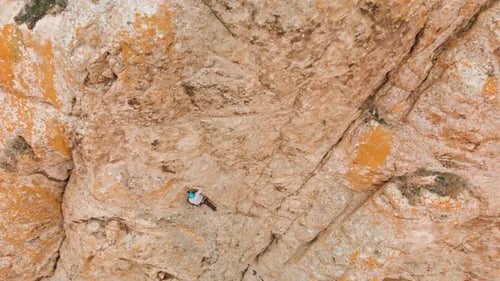 Man Athlette Climbing on the High Rock