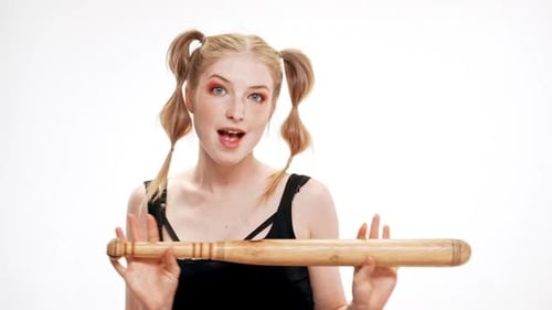Smiling Woman Holds Baseball Bat in Studio