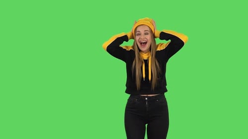 Modern Girl in Yellow Hat with Shocked Surprised Wow Face Expression Is Rejoicing. Green Screen