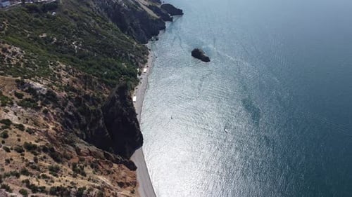 Aerial View From Above on Calm Azure Sea and Volcanic Rocky Shores