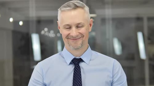Professional Man Smiling Gently in Modern Office