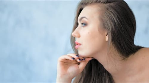 Fashion Model with Professional Beauty Makeup Posing in Studio