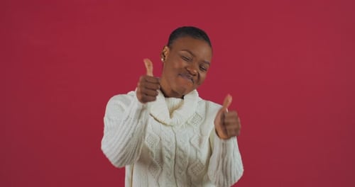 Studio Portrait of Afro American Girl Standing on Red Background Shows Gesture of Approval of