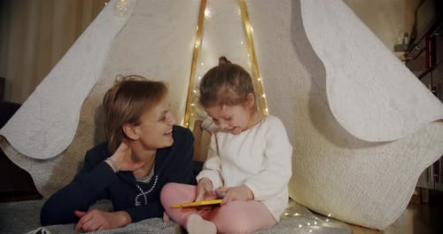 Mother and Child Playing in Blanket Fort