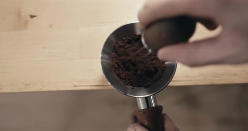 Mixing Fresh Coffee Grounds in Portafilter Close Up