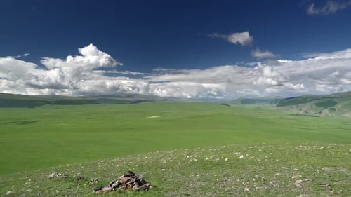 Green Mountain Meadow with Blue Sky and Clouds