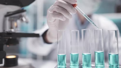 Pipette Adding Solution to Test Tubes in Lab