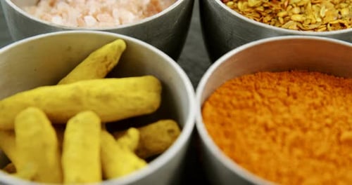 Various Culinary Spices and Ingredients in Bowls