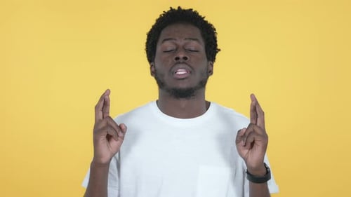 Man with Fingers Crossed Looking Upward for Luck