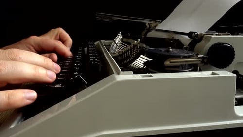 Hands Typing on a Vintage Manual Typewriter
