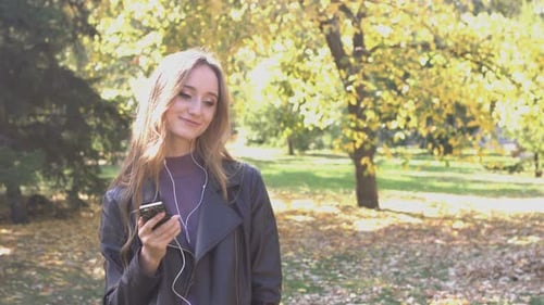 Girl listens to Music in Park