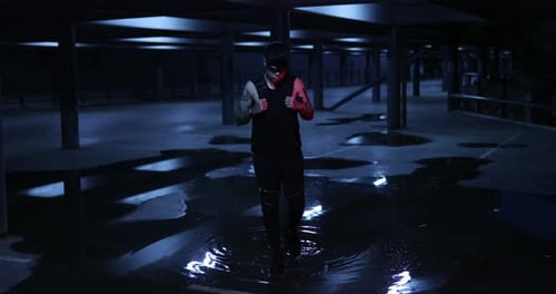 Edgy Young Adult Posing in Rainy Urban Setting