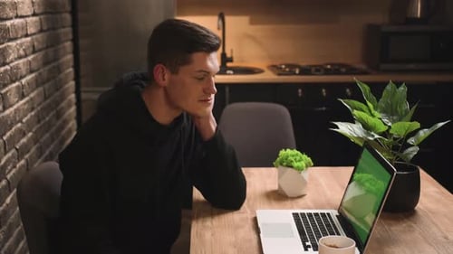 Smiling Handsome Businessman Looking Laptop Monitor Green Screen at Home Office